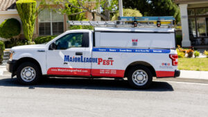 Major League Pest pickup truck in front of a home on a service route